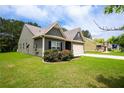 Attractive one-story home with an attached garage, verdant lawn, and blooming rose bushes at 142 Susie Creek Ln, Villa Rica, GA 30180