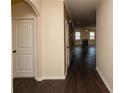 Inviting hallway with hardwood floors leading to an open living space featuring a fireplace at 142 Susie Creek Ln, Villa Rica, GA 30180
