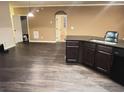 Open-concept kitchen featuring dark wood cabinets, granite countertops, and modern appliances at 142 Susie Creek Ln, Villa Rica, GA 30180