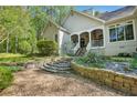 Multi-tiered backyard features stone walls, steps, and lush landscaping at 2095 Southers Cir, Suwanee, GA 30024