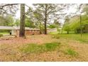 Expansive backyard, partially cleared, with a view of neighboring properties and mature trees at 5032 Central Church Rd, Douglasville, GA 30135