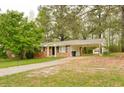 View of a one-story brick home with a carport and a storage shed in the backyard at 5032 Central Church Rd, Douglasville, GA 30135
