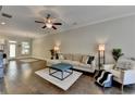 Open-concept living room with hardwood floors, modern furniture, and ample natural light at 1372 Doublegate Dr, Atlanta, GA 30319