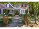 Charming walkway leads to a classic front door framed by lush greenery and brick columns at 415 Westlake Nw Ct, Marietta, GA 30064