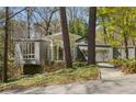 Beautiful exterior view of modern home with unique architecture and wooded lot at 1105 Crest Valley Dr, Sandy Springs, GA 30327