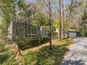 Exterior view of the house and garage surrounded by mature trees and landscaping at 1105 Crest Valley Dr, Sandy Springs, GA 30327