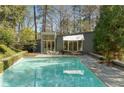 Outdoor pool area featuring a spacious pool, patio, and manicured garden at 1105 Crest Valley Dr, Sandy Springs, GA 30327