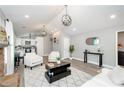 Spacious living room with vaulted ceilings, modern decor, and seamless flow to the kitchen at 238 Knob Hill Dr, Locust Grove, GA 30248