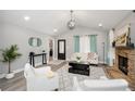 Bright living room featuring stone fireplace, vaulted ceilings, and stylish decor at 238 Knob Hill Dr, Locust Grove, GA 30248