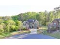 Brick home with well-manicured lawn and landscaping on a verdant lot at 4155 Winterberry Rd, Cumming, GA 30040