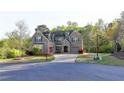 Brick home featuring well-maintained landscaping, a driveway, and an attached garage at 4155 Winterberry Rd, Cumming, GA 30040