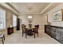 Formal dining room with a decorative chandelier, tray ceilings and ample space for entertaining at 105 Aspen Hall Dr, Canton, GA 30115