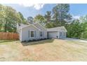 Lovely ranch home with green lawn, charming shutters, and classic architectural details at 315 Fieldridge Dr, Lawrenceville, GA 30045