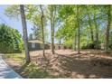 A beautiful home sits on a wooded lot with a long driveway at 3350 Pine Meadow Nw Rd, Atlanta, GA 30327