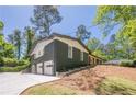 Beautiful two-story home with painted brick, 3-car garage, and mature trees at 3350 Pine Meadow Nw Rd, Atlanta, GA 30327