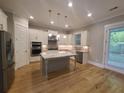 Modern kitchen featuring white cabinets, stainless steel appliances, and a granite island at 2071 Westside Blvd, Atlanta, GA 30318
