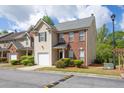 Attractive townhome featuring well-manicured shrubs, a single-car garage, and a paved street at 2602 Avery Park Cir, Atlanta, GA 30360