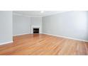 Bright living room with gleaming hardwood floors and a cozy fireplace with marble hearth at 2602 Avery Park Cir, Atlanta, GA 30360