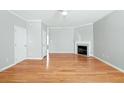 Inviting living room featuring hardwood floors, a ceiling fan, and a fireplace at 2602 Avery Park Cir, Atlanta, GA 30360