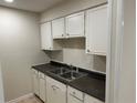 Efficient kitchen with white cabinetry and black countertops at 3071 Colonial Way # K, Atlanta, GA 30341
