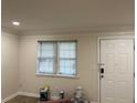 Bright living room with fresh paint, crown molding and a window for natural light at 3071 Colonial Way # K, Atlanta, GA 30341