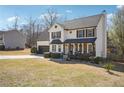 Inviting home featuring a covered porch, manicured bushes, and a spacious driveway, perfect for a growing Gathering at 161 Hunters Chase, Mcdonough, GA 30253