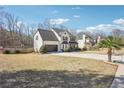 Suburban home with a side-entry garage, surrounded by a green lawn and mature trees, ideal for outdoor living at 161 Hunters Chase, Mcdonough, GA 30253