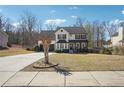 Traditional home with a well-kept lawn, a long driveway, and mature trees, offering a serene suburban setting at 161 Hunters Chase, Mcdonough, GA 30253