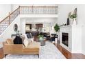 Open floor plan with a living room featuring a fireplace, staircase, and view of the kitchen at 360 Beracah Sw Trl, Atlanta, GA 30331
