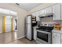Well-lit kitchen features stainless steel appliances, white cabinetry, and access to the dining room, creating an open and inviting space at 4657 Tartan Ct, Union City, GA 30291