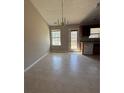 A well lit dining area with an overhead chandelier and access to the exterior patio at 8302 N Sterling Lakes Dr, Covington, GA 30014