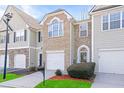 Attractive townhome with brick facade, attached garage, and tidy front lawn at 1688 Jackson Sq, Atlanta, GA 30318