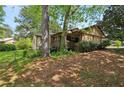 Home exterior showing a brick and siding, a small covered porch, and mature trees at 1911 Lavista Ne Rd, Atlanta, GA 30329