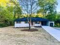 Charming, updated home featuring light brick, dark trim, wooden shutters, and a convenient carport at 7817 Mattie Mccoy Ln, Winston, GA 30187