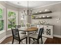 Cozy breakfast nook with bright windows, modern chandelier, and charming decor at 1165 Evergreen Oak Way, Dacula, GA 30019