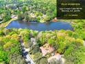 Picturesque aerial view of a property with a lake, surrounded by lush greenery and mature trees at 1531 Cooper Lake Se Rd, Smyrna, GA 30082
