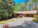 Charming single-story home with a well-manicured lawn and mature trees providing shade at 1531 Cooper Lake Se Rd, Smyrna, GA 30082