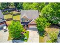 An aerial view showcases the home's landscaping, spacious backyard, and surrounding neighborhood at 1691 Scenic Pines Dr, Lawrenceville, GA 30044
