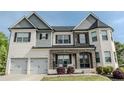 Beautiful two-story home with a brick and siding exterior, two-car garage, and manicured lawn at 4685 Columbia St, Cumming, GA 30040