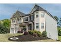 Stunning two-story home with a brick and siding exterior, professional landscaping and a manicured lawn at 4685 Columbia St, Cumming, GA 30040