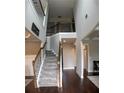 Inviting foyer featuring high ceilings, elegant staircase with wooden rails, and hardwood floors at 4685 Columbia St, Cumming, GA 30040