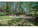 Backyard oasis featuring a stone-lined pool and a patio perfect for outdoor living at 965 River Overlook Ct, Sandy Springs, GA 30328