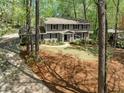 Exterior view of the property showcasing its well-manicured lawn and mature trees at 965 River Overlook Ct, Sandy Springs, GA 30328