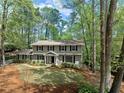 Beautiful home surrounded by lush trees offering privacy and curb appeal at 965 River Overlook Ct, Sandy Springs, GA 30328
