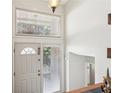 Bright foyer featuring a white front door, neutral walls, and an elegant pendant light fixture at 1496 Country Squire Dr, Decatur, GA 30033