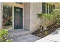 Classic brick facade showcasing an inviting front door with sidelight and manicured landscaping at 1496 Country Squire Dr, Decatur, GA 30033