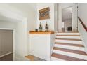 Elegant staircase with wood treads and white risers leading to a cozy living space with a fireplace at 1496 Country Squire Dr, Decatur, GA 30033