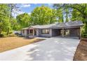 Inviting single-story home with a convenient covered carport and extended driveway at 1995 Mcafee Rd, Decatur, GA 30032