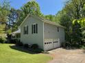 Rear view of the home showcasing an attached two-car garage at 861 Creek Nw Trl, Kennesaw, GA 30144