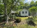 Charming single-Gathering home with covered porch and beautiful landscaped yard with lawn at 861 Creek Nw Trl, Kennesaw, GA 30144